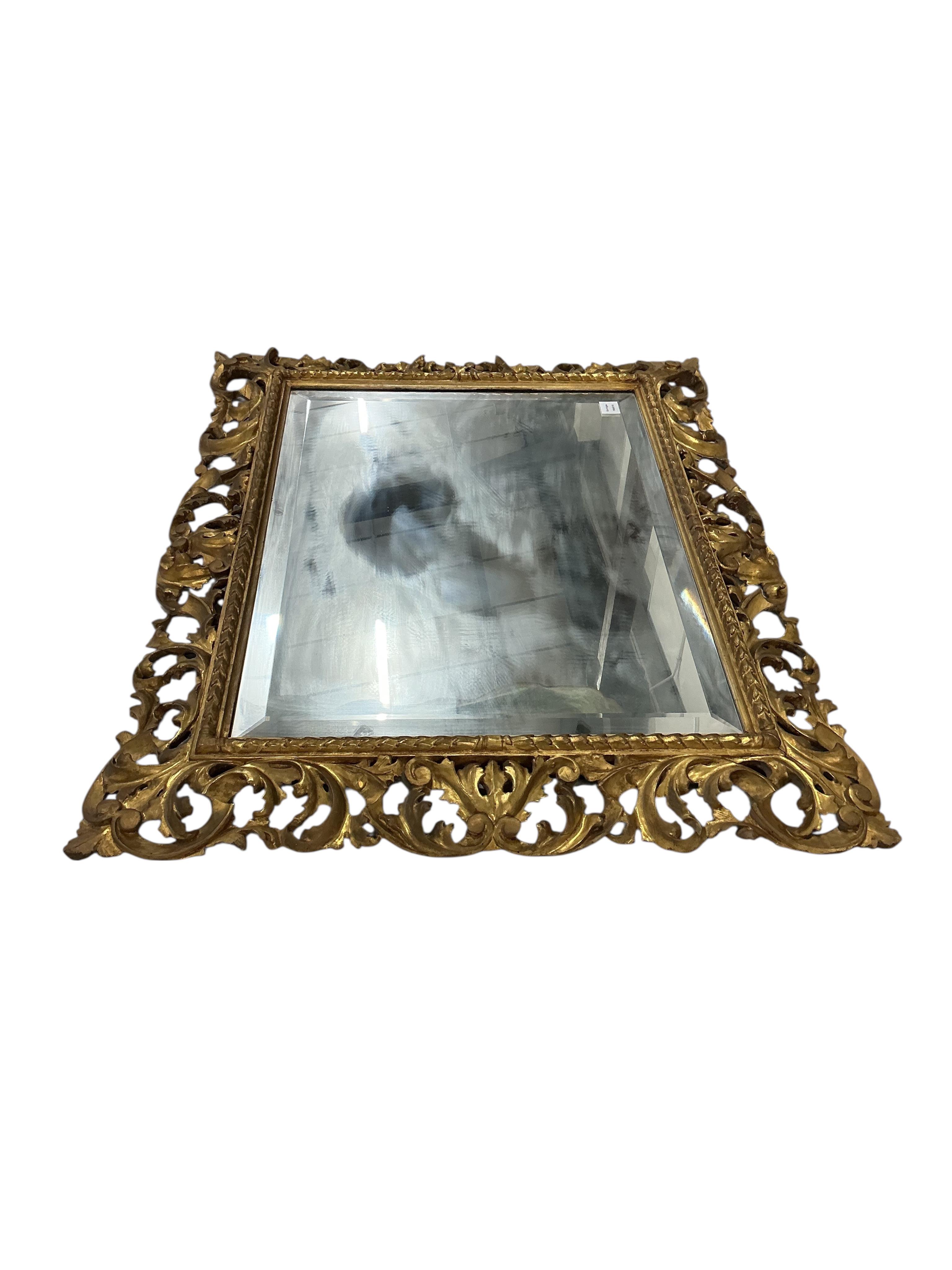 A large 19th century Florentine style carved giltwood rectangular wall mirror, width 112cm, height 89cm